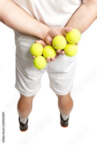 A man holds tennis balls in his hands. Back view. Close-up. Vertical. Isolated on a white background.
