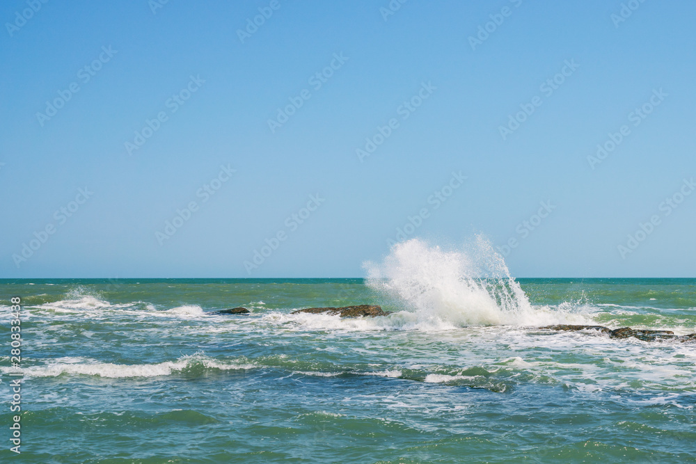 Waves breaking on coastal reefs, big splashes