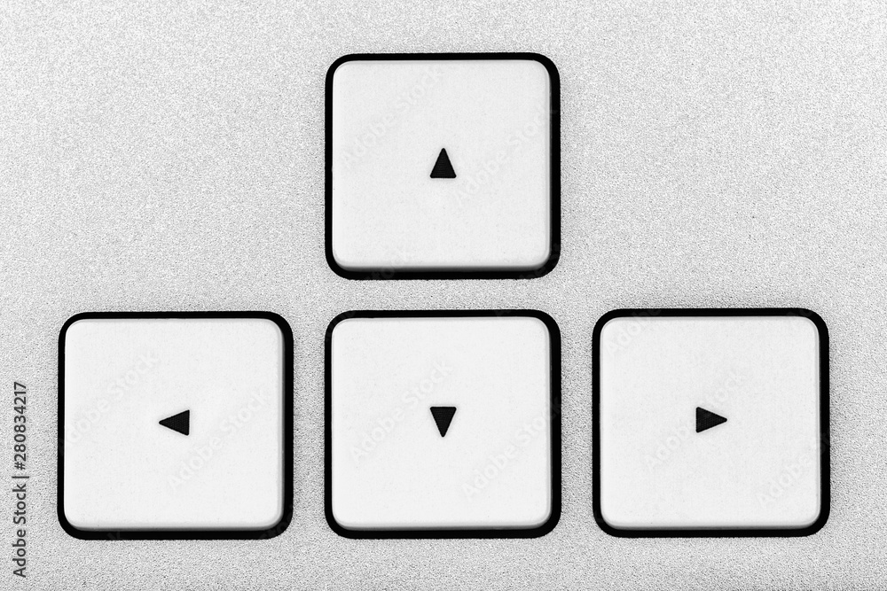 White aluminum arrow button close-up keyboard White aluminum arrow button close-up keyboard