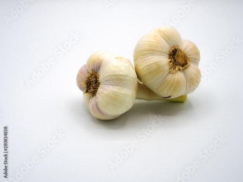 two tuber garlic separated on white background