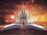 Open story book with fairy tale castle.