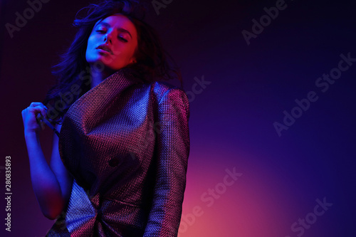 High fashion girl model in stylish clothing in color neon light