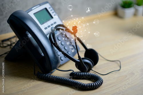 VOIP services concept of IP telephone device and headset with flying icon of voip services