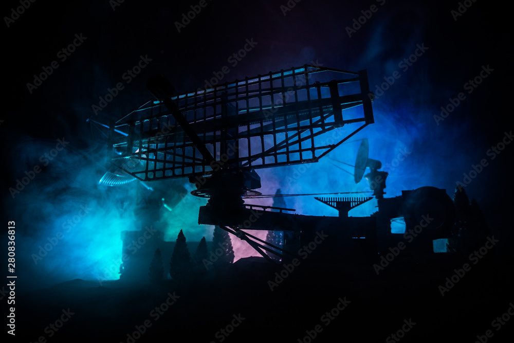 Silhouettes of satellite dishes or radio antennas against night sky. Space observatory.