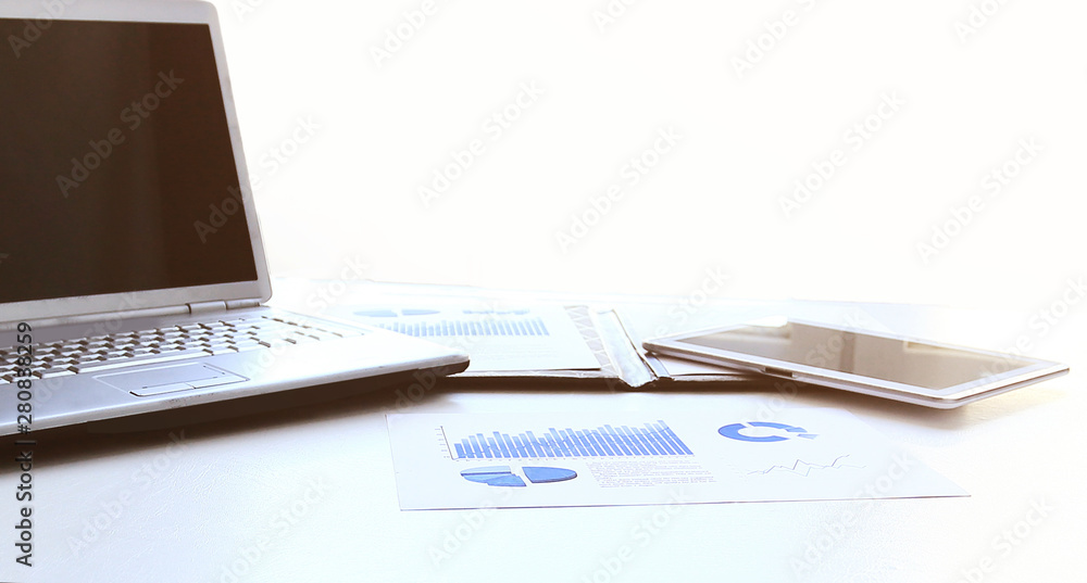 laptop,digital tablet with financial graph on the desktop laptop,digital tablet with financial graph on the desktop