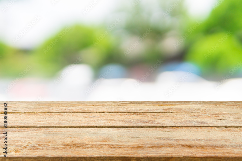 Empty wooden table top with blurred natural background. Can be used for display or montage your products. Empty wooden table top with blurred natural background. Can be used for display or montage your products.