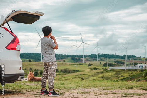 Young man tourist watching windmill