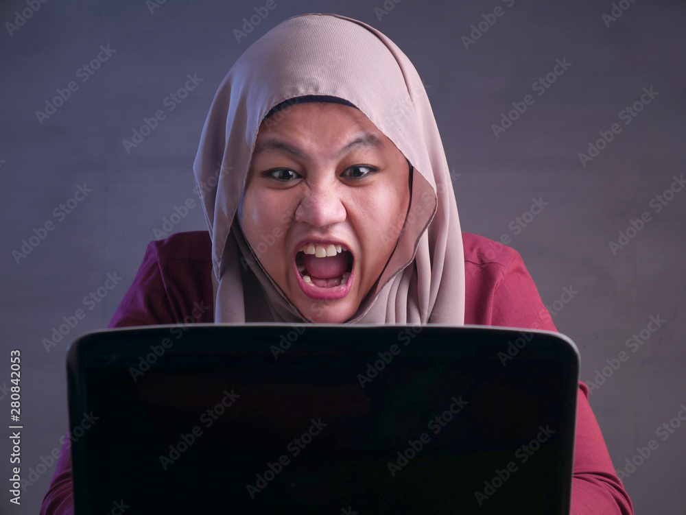 Angry Muslim Businesswoman Working on Laptop at the Office Angry Muslim Businesswoman Working on Laptop at the Office