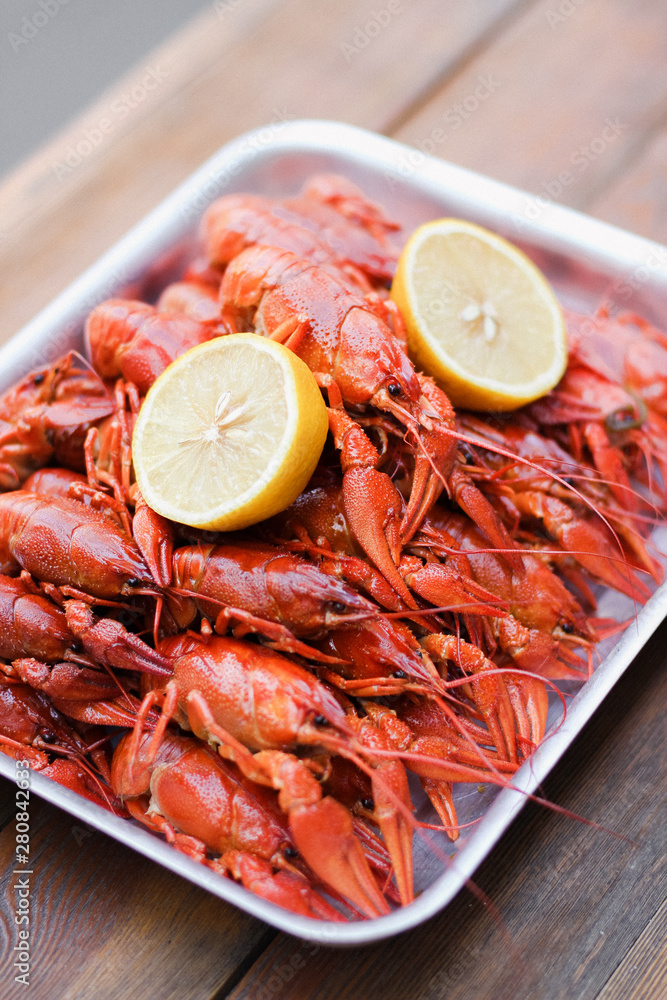 A lot of bright red boiled crawfish with lemon A lot of bright red boiled crawfish with lemon