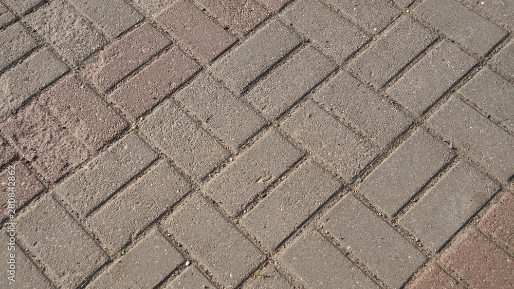 Old grey concrete tiles on the road, pattern texture background for design. Old grey concrete tiles on the road, pattern texture background for design.