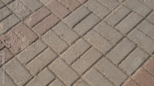Old grey concrete tiles on the road, pattern texture background for design.
