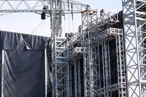Details with the metallic structure of a large concert stage seen from behind, at a music festival photo