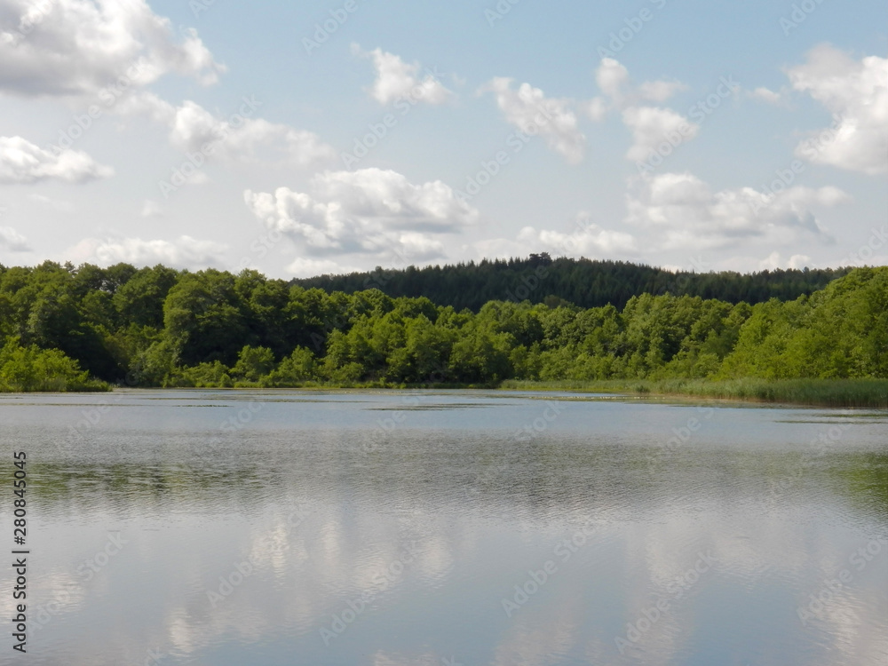 One HDR landscape of a large area with some green colors tree and a intense reflection with the light of this day. Water and outdoors One HDR landscape of a large area with some green colors tree and a intense reflection with the light of this day. Water and outdoors