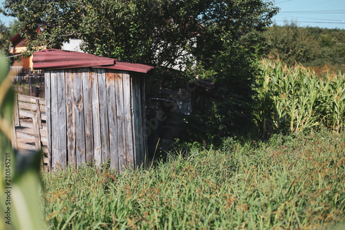 Wooden outdoor toilet in a village in rural Romania photo