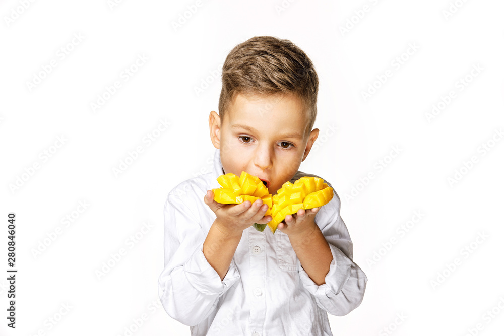 handsome boy in a white shirt is eating a mango handsome boy in a white shirt is eating a mango