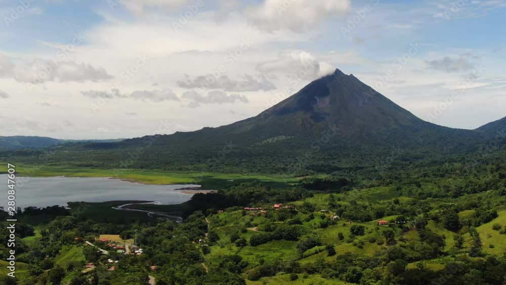 Costa Rica village with clear view of Arenal Volcano peak in background Costa Rica village with clear view of Arenal Volcano peak in background