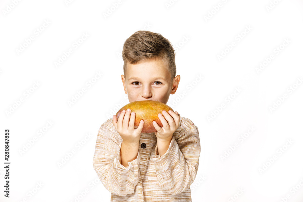 handsome pretty boy is holding a mango handsome pretty boy is holding a mango