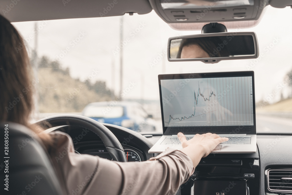 Business woman working using laptop while driving car on the high speed on the highway . Business woman working using laptop while driving car on the high speed on the highway .