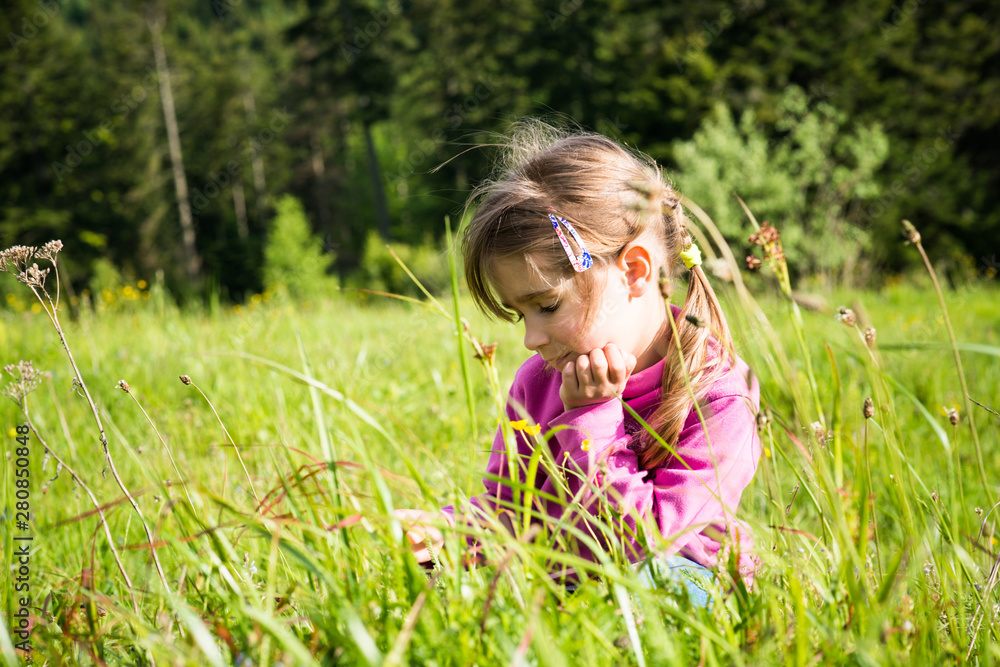 Fototapeta premium Girl on a flowering meadow.