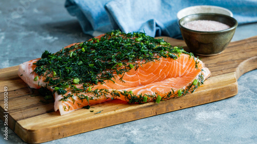 Gravlax or gravlaks is a Nordic dish consisting of raw salmon, cured in salt, sugar, and dill photo