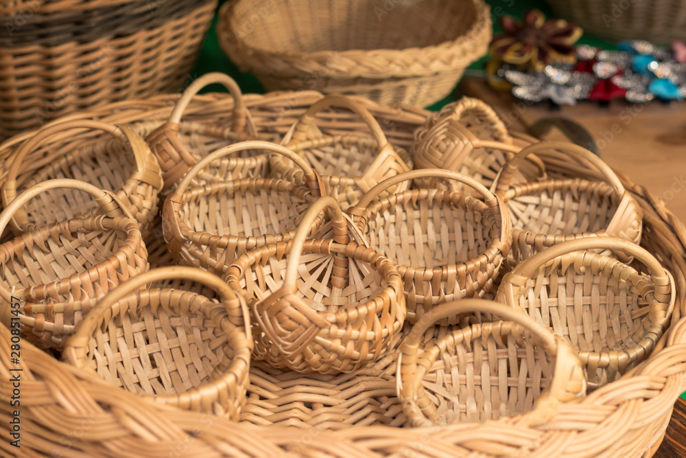 little straw woven baskets in a large basket. Souvenirs and decor from straw. little straw woven baskets in a large basket. Souvenirs and decor from straw.