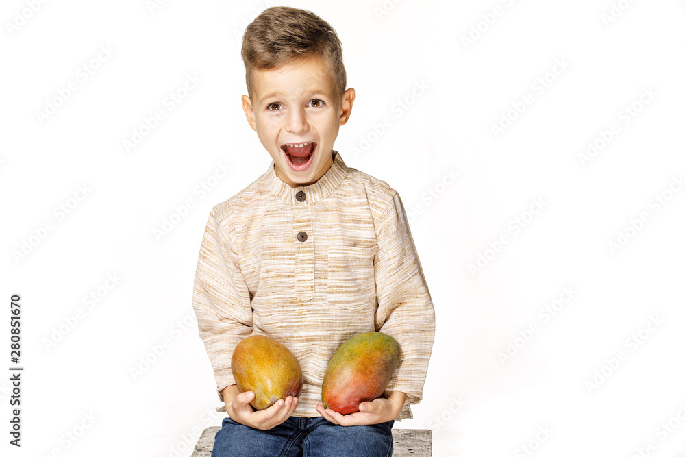 Fototapeta premium handsome pretty boy is holding a mango 