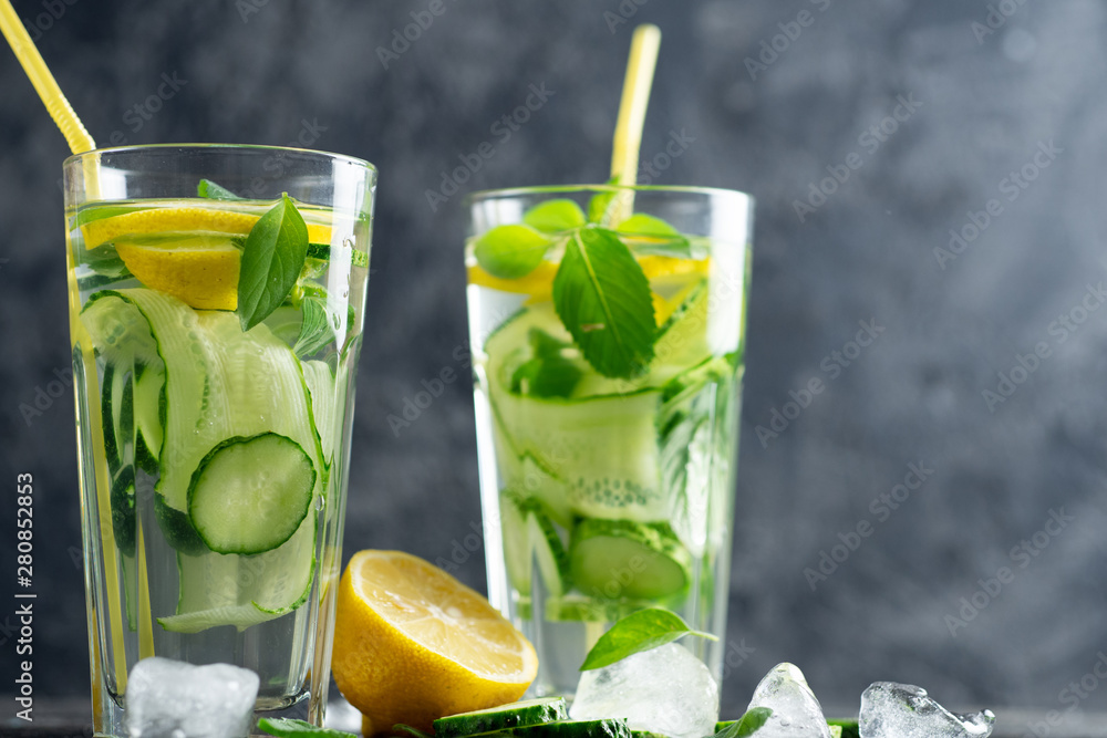 Fototapeta premium Summer detox water with lemon, mint, cucumber and Basil. Summer chilled lemonade