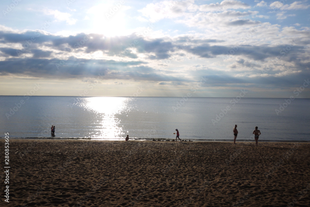 People relax in the summer on the beach. People relax in the summer on the beach.