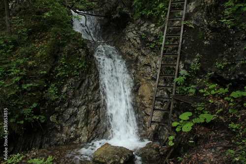 Fototapeta Naklejka Na Ścianę i Meble -  Dangerous trail through a waterfall with steel ladders in the Slovak Paradise National Park, Slovaki