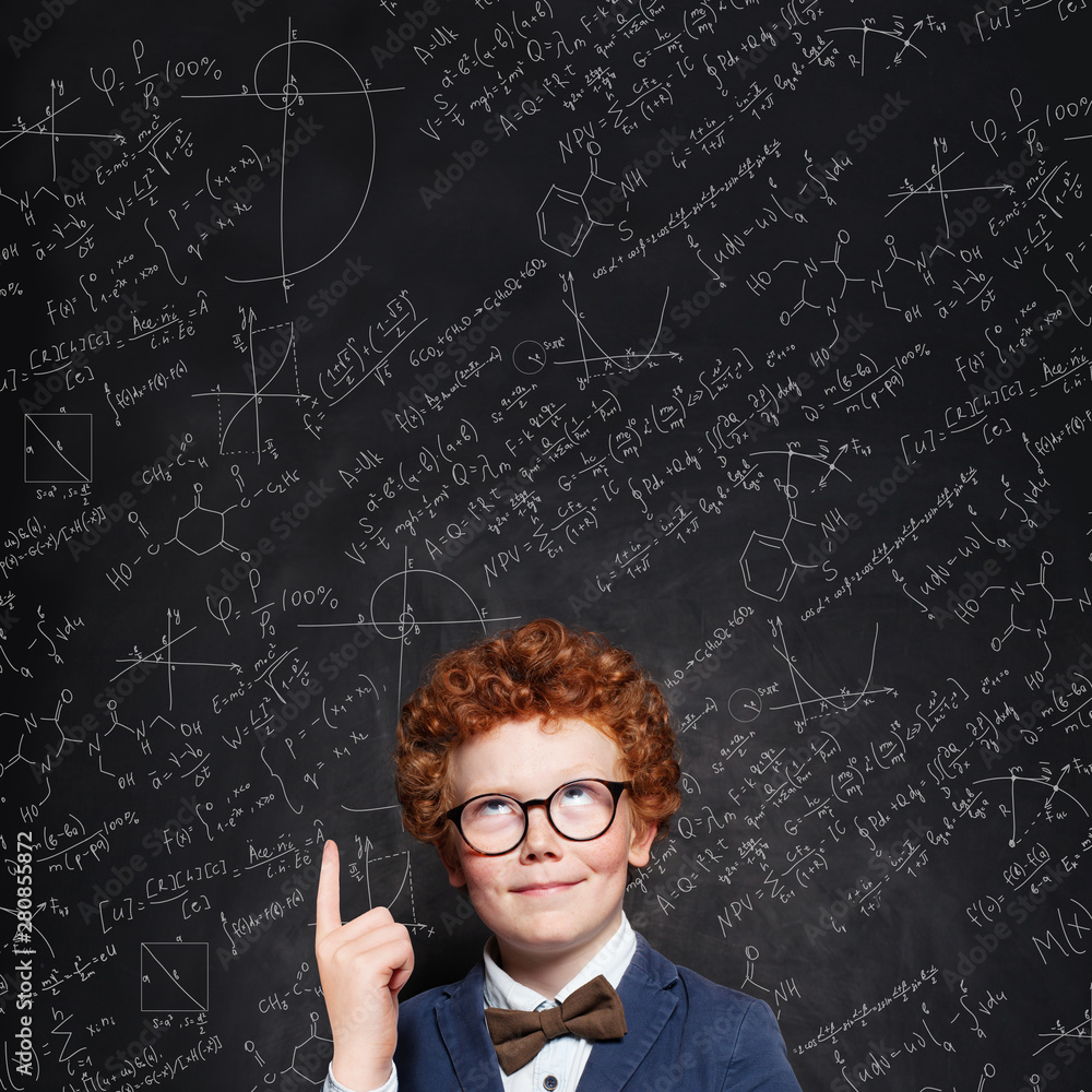 Smart child boy with curly ginger hair in glasses. Genius kid portrait Smart child boy with curly ginger hair in glasses. Genius kid portrait