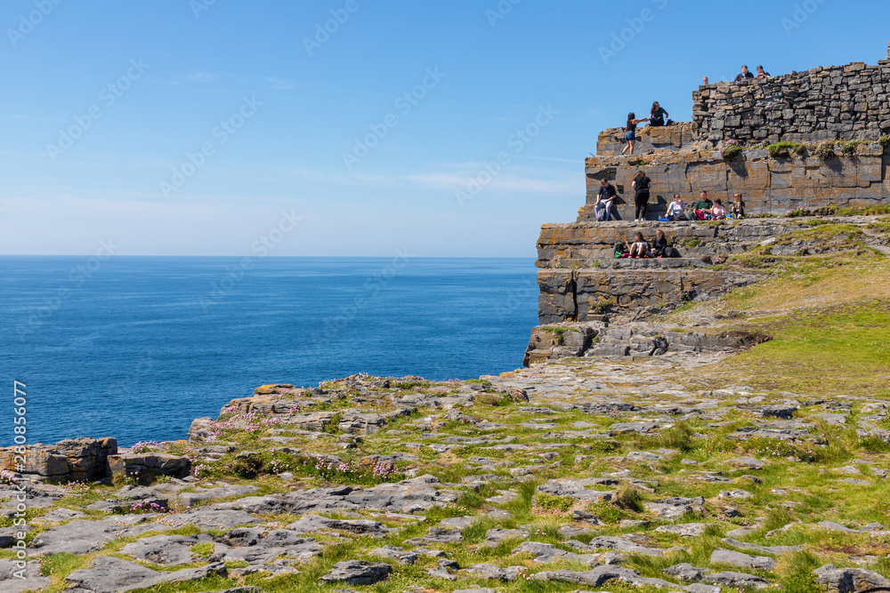 Tourists visiting Dún Aonghasa Fort in Inishmore