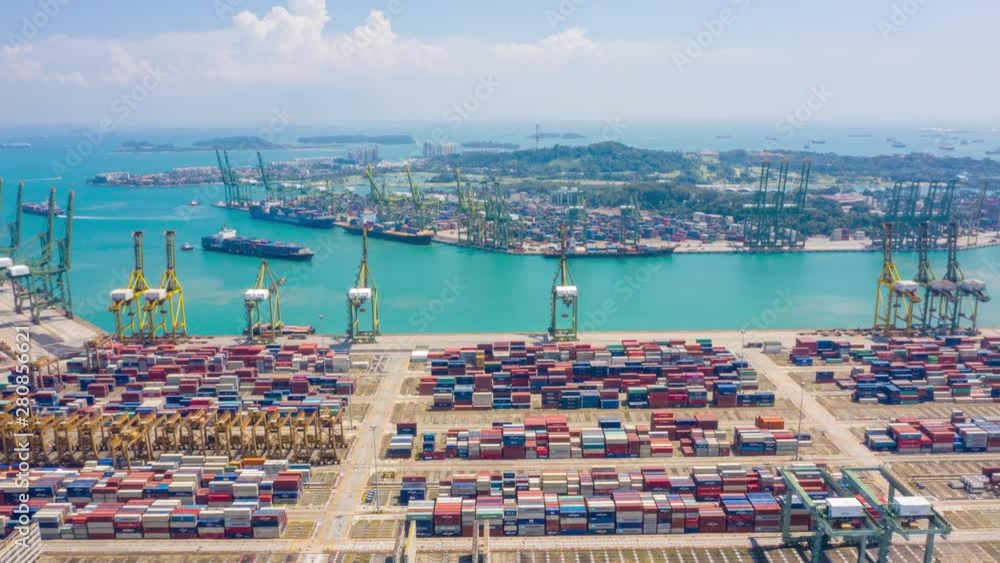 aerial view hyperlapse 4k video of busiest Asian cargo port with hundreds of ships loading export and import goods and thousands of containers in harbor singapore.