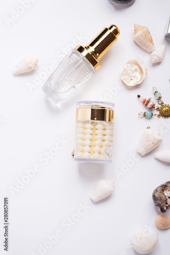 precious skin care cosmetics around natural shells and gemstones. close up