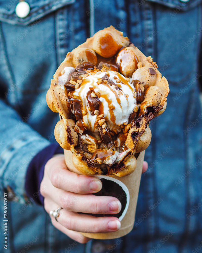 Hong Kong waffles in female hand. Girl 