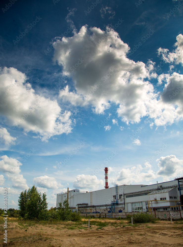 Obraz premium Clouds in the blue sky over the plant. Ecology, environment