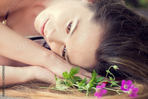 The woman with a natural make-up relaxes outdoors photo