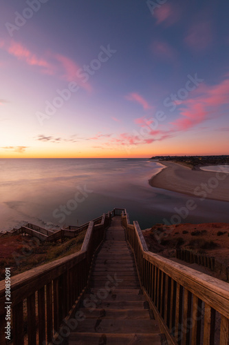 Stair to go down into the beach view during colorful sunset.