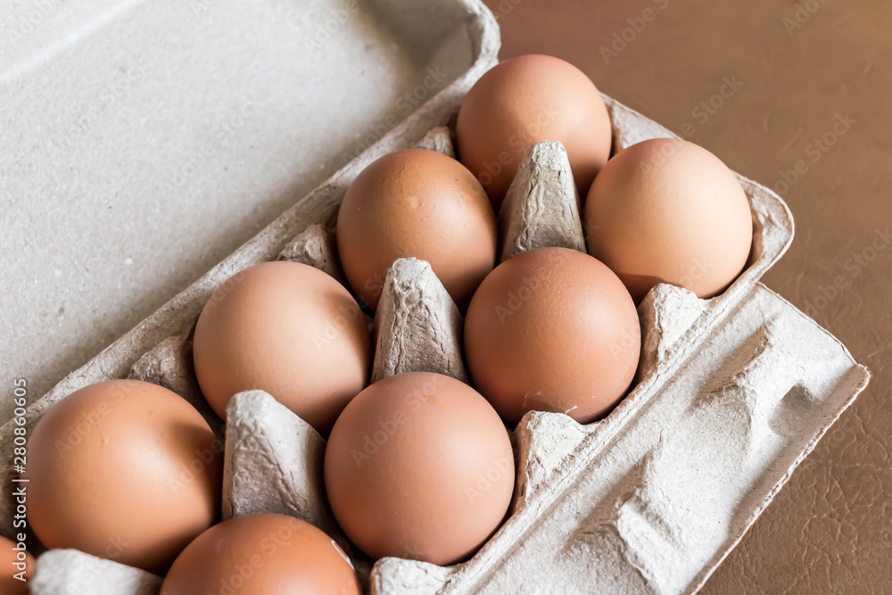 Close-up view of raw chicken eggs in egg box. Close-up view of raw chicken eggs in egg box.