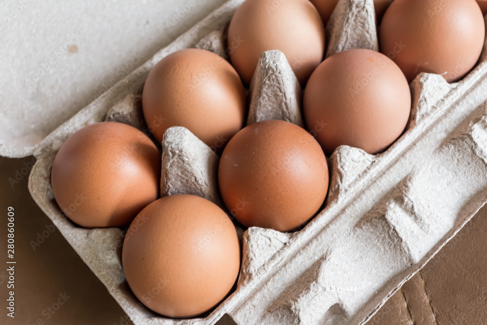 Close-up view of raw chicken eggs in egg box. Close-up view of raw chicken eggs in egg box.