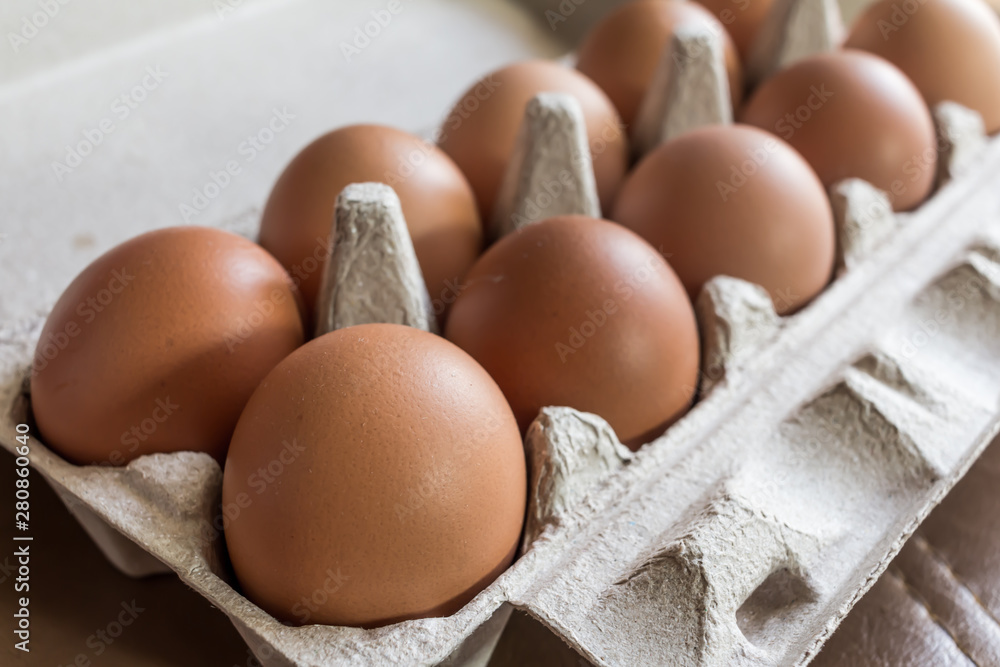 Close-up view of raw chicken eggs in egg box. Close-up view of raw chicken eggs in egg box.