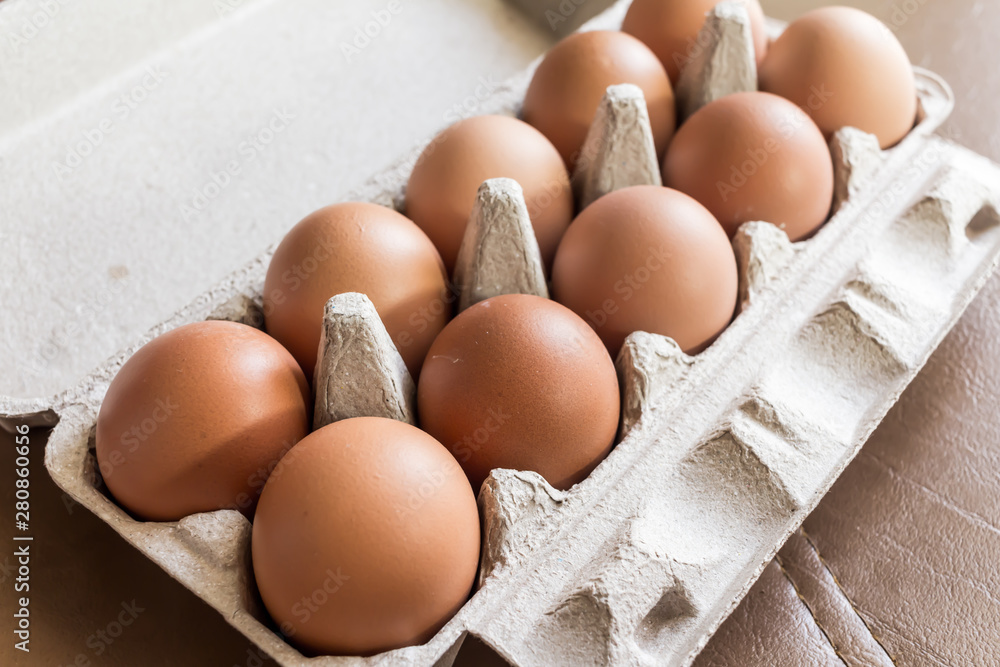 Close-up view of raw chicken eggs in egg box. Close-up view of raw chicken eggs in egg box.