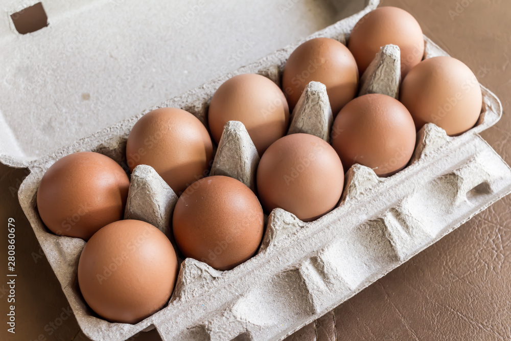 Close-up view of raw chicken eggs in egg box. Close-up view of raw chicken eggs in egg box.