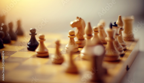 Wooden chess pieces on the chessboard. © Azaliya (Elya Vatel)
