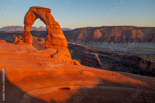 The beautiful Delicate Arch glowing red at sunset in Arches National Park