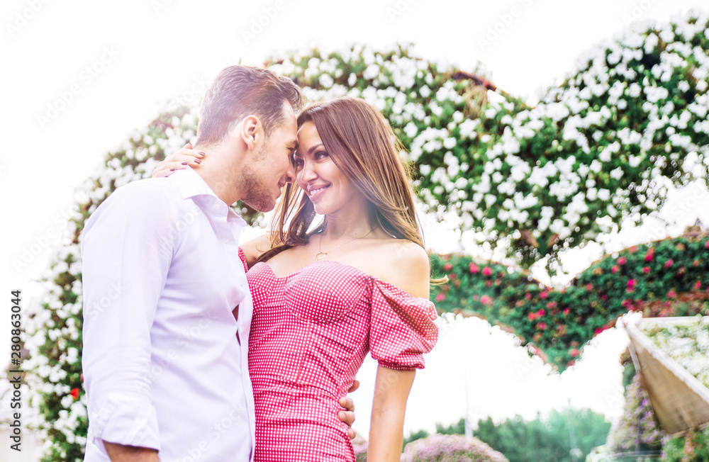 Fototapeta premium Happy couple walking in a flower park