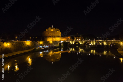 Rome Italy. Night View of famous Sant Angelo Bridge and The Mausoleum of Hadrian, known as the Castel Sant Angelo. River Tiber.