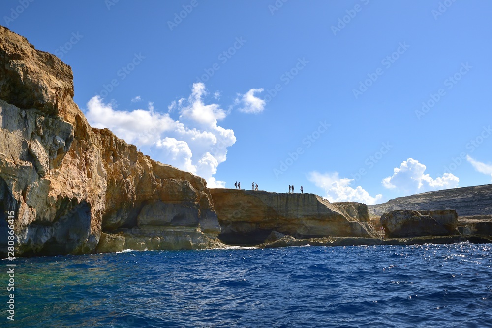 Toursits on the Gozo cliffs