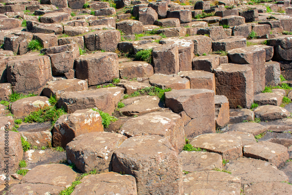 Giants Causeway most popular and famous attraction in Northern Ireland. Hexagon basalt columns after volcanic eruption Giants Causeway most popular and famous attraction in Northern Ireland. Hexagon basalt columns after volcanic eruption