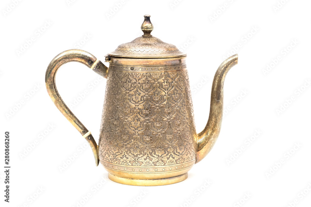 An antique silver teapot on a white background. An antique silver teapot on a white background.