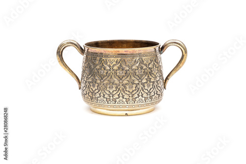 Old silver sugar bowl without a lid on a white background.